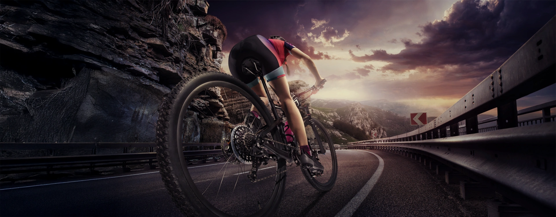 woman cycling on a mountain road at high speed